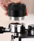 Pro Grade 51mm Coffee Distributor Leveler Heavy Duty Stainless Steel Espresso Tool in use over portafilter with ground coffee.