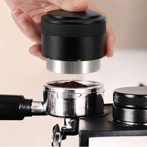Pro Grade 51mm Coffee Distributor Leveler Heavy Duty Stainless Steel Espresso Tool in use over portafilter with ground coffee.