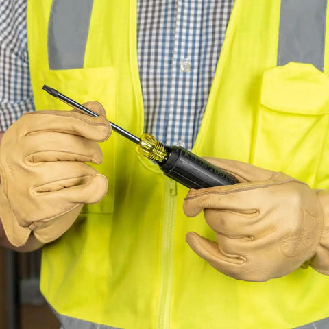 Person holding TORX Cushion Grip Screwdriver Set, 5 Piece With T15 T20 T25 T27 T30 Bits, shown with chrome shaft and color-coded handle.