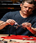 Man using a 5 to 30 Watt Precision Soldering Iron Station with adjustable wattage, compact 120V design, for pro crafters and DIY enthusiasts