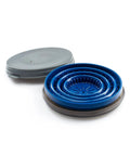 Collapsed blue Collapsible Pour Over Travel Coffee Maker with Silicone Cone Dripper next to its closed gray lid