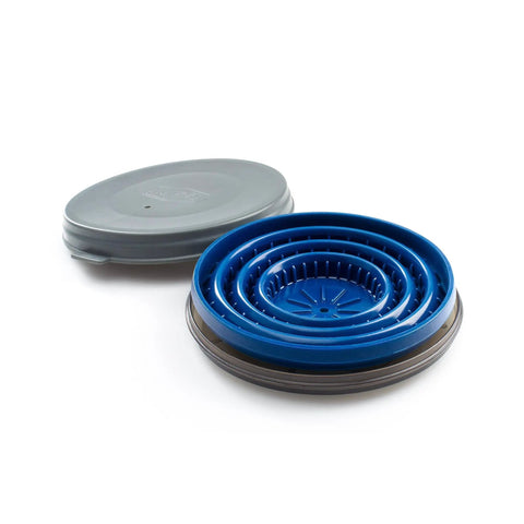 Collapsed blue Collapsible Pour Over Travel Coffee Maker with Silicone Cone Dripper next to its closed gray lid