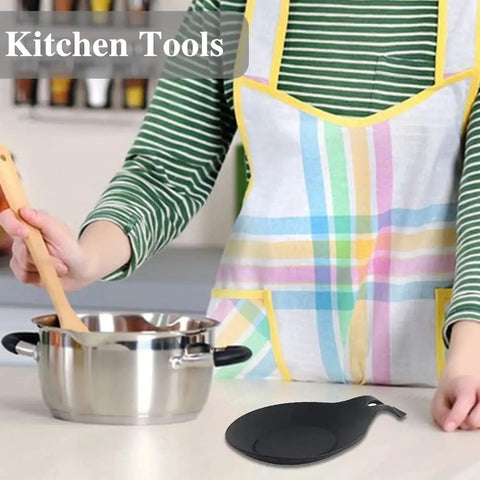 Person stirring pot with spoon, black silicone rest from Three Piece Silicone Spoon Rest Set For Stove Top And Kitchen Counter visible