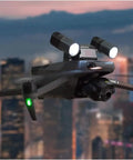 Drone flying over city at dusk with T30 Spotlight Kit For Mavic 3 Enterprise Drones 3E 3T SDK Ready Mount Replacement Accessory Durable Build.