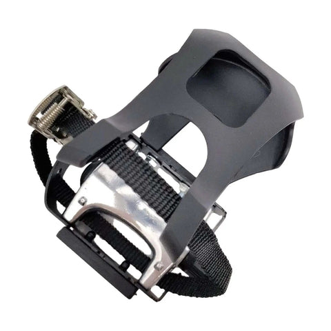 Close-up of bike pedals with toe clips and straps for indoor cycling and home gym training, showing the grippy non-slip surface.