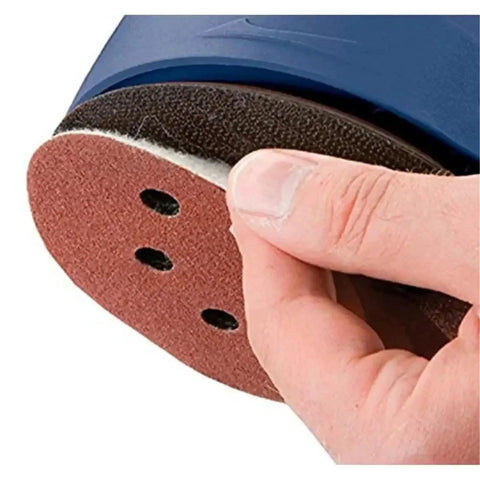 Hand holding a five inch sanding disc with hook loop straps, showing eight holes for dust reduction. Get Your Hands On These 100 Pcs Of Rad Five Inch Sanding Discs With Eight Holes Hook Loop Straps For Super Smooth Drying And Heavy Duty Polishing Jobs Across Wood Metal Or Plastic Surfaces In Assorted Grit Ranging From Rough sixty Up To Ultra Fine Six.