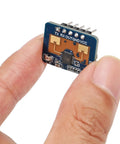 Close-up of Two Pack Dope 24GHz Human Presence Radar Sensor Module LD2410C held between fingers, showing circuit components.