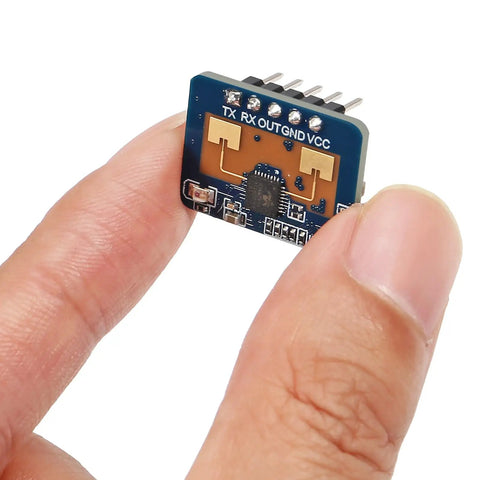 Close-up of Two Pack Dope 24GHz Human Presence Radar Sensor Module LD2410C held between fingers, showing circuit components.