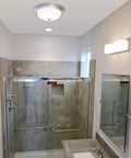 Round Bath Fan With Light In Nickel Finish, 70 CFM Vent With Decorative Grill And Frosted Glass Lens installed in bathroom ceiling