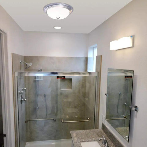Round Bath Fan With Light In Nickel Finish, 70 CFM Vent With Decorative Grill And Frosted Glass Lens installed in bathroom ceiling