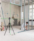 Built Tough Green Beam Cross Line Level With Razor Sharp Point Laser And Reliable Long Haul Battery Life For Fast Wall Layouts in use on job site.