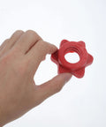Hand holding a Red Plastic Barbell Self Locking Nut from 4 Pack Clasp Design Dumbbell Locking Nuts for Home Gym Weightlifting.
