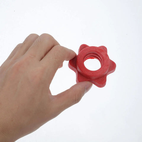 Hand holding a Red Plastic Barbell Self Locking Nut from 4 Pack Clasp Design Dumbbell Locking Nuts for Home Gym Weightlifting.