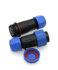 TY20 2 Pin Waterproof Solder Free Screw Connection Panel Mount Cable Plug Socket For Outdoor Electrical Solar Power Easy Snap Quick Disconnect For Male And Female Wires 25A 380V Weatherproof Connector front view showing blue caps and black housing