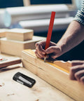 10 Piece Carpenter Pencil Set With 7 Inch Flat Octagonal Black Pencils Heavy Duty Woodworking Tools Includes Sharpener Eraser And Utility Knife Pro Grade Marking Kit For Contractors Carpenters And DIY Projects in use, showing precise wood marking with pencil and knife on a workbench.