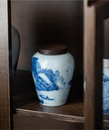 Ceramic Airtight Tea Canister With Heavy Duty Wooden Lid For Loose Leaf Stashing And Coffee Bean Storage Artisan Handpainted Kitchen Jar on a shelf.