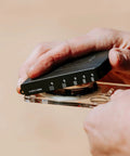 Hands holding Advanced Mirror Compass For Pros And Serious Hikers With Metric UTM Scales And Inch Ruler.