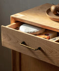 Wooden dresser with an antique brass cabinet bar pull, 3 inch center to center, showing retro style handle on the drawer front.