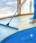 Built Like A Tank 30 Inch Silicone Floor Squeegee With Rust Resistant Stainless Aluminum Pole used on tiled floor near a pool.