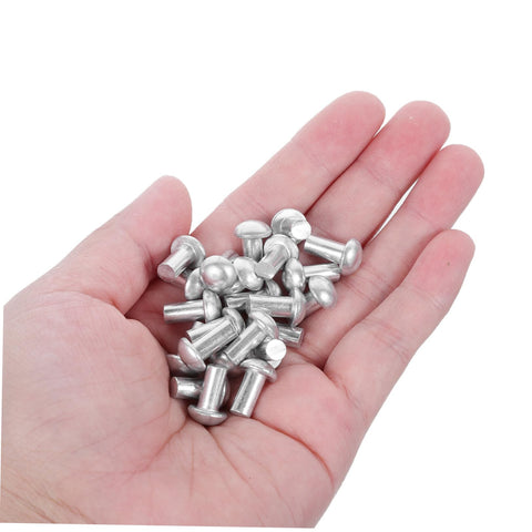 Hand holding multiple 200 Pcs Solid Aluminum Dome Head Rivets M5x10 for DIY projects and workshop builds.