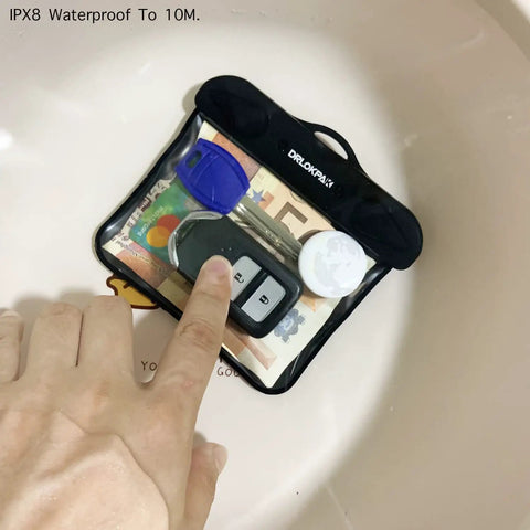 IPX8 Submersible Waterproof Wallet And Key Fob Case Pouch with keys, cash, and ID submerged in water for safety demonstration