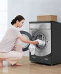 Person using front loading washer and dryer with Heavy Duty Oxford Fabric Waterproof Dustproof Shield Cover, Black 1 Pack.