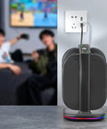 Controller Fast Charging Station With Touch Glow Lights For Nintendo Switch 2 Featuring 9 Color Breathing Modes Instant Status Tracking Quick Plug Play Gaming Rgb Vibe Dock positioned on a table near a wall outlet.