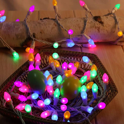 Easter String Lights LED Multi Color Glass C3 Bulbs 50 Count For Party Vibes On Patio And At Home, coiled on wooden surface.