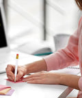 Person using a pencil at a desk, focus on 24 Pack Mini White Golf Pencils With Erasers, Short Hexagon Wooden 2B Graphite Pencils