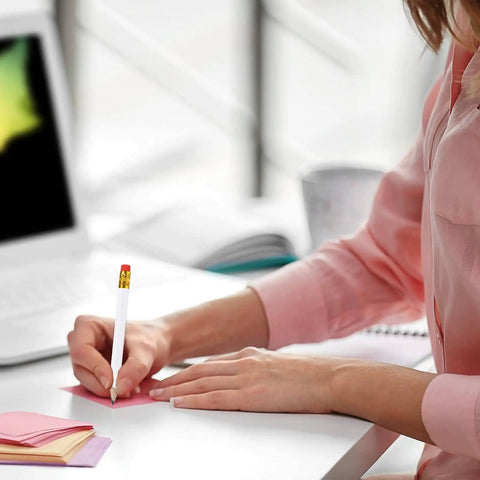 Person using a pencil at a desk, focus on 24 Pack Mini White Golf Pencils With Erasers, Short Hexagon Wooden 2B Graphite Pencils