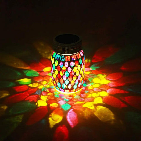 Outdoor Mosaic Lanterns Solar Powered Hanging Lights illuminating colorful patterns with warm white glow on a dark surface.