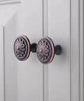 Oil Rubbed Bronze Flower Shaped Cabinet Knob Set 12 Pack For Cabinets And Drawers installed on white cabinet doors