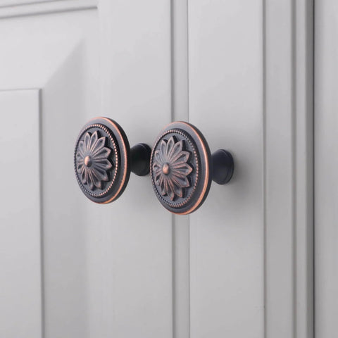 Oil Rubbed Bronze Flower Shaped Cabinet Knob Set 12 Pack For Cabinets And Drawers installed on white cabinet doors
