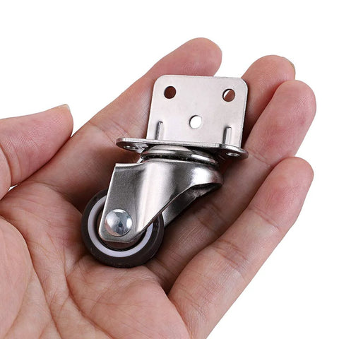 Hand holding a Four Pack 1 Inch Side Mounting Casters With TPE Swivel Plated Wheels L Shaped Mute Wheel For Baby Beds Carts Trolleys