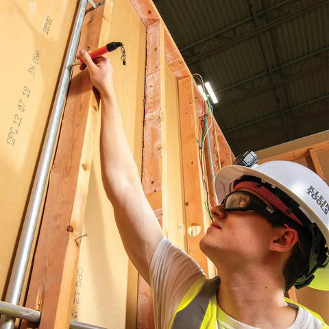 Construction worker using Retractable Marker Holder With Four Foot Cord For Skribes Paint Markers Fits Ultra Fine Fine And Chisel Tip Permanent Markers Keeps Pencils And Markers Handy On The Job on wood frames.