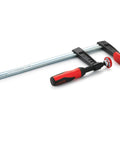 Tradesman Clamp With Four Inch Throat Depth And Twelve Inch Reach In Black And Red Heavy Duty Woodworking Clamp With Patented Serrated Rails For Anti Slip Grip And Buckle Free Lock Ergonomic Wooden Handles Made In USA, side view
