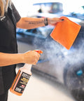 Person spraying Bead Maker Paint Sealant For No Fuss Spray And Wipe Protection On Cars, Boats, And RVs With Hydrophobic Gloss