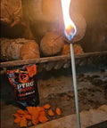 A match lighting near Fire Balls Fire Starter Pellets For Easy Fire Lighting, 7 Minute Burn Time, Waterproof And Weatherproof Emergency Kit Survival Gear, Ideal For Campin, Grillin, And Outdoor Prep, 30 Pack with logs in background.