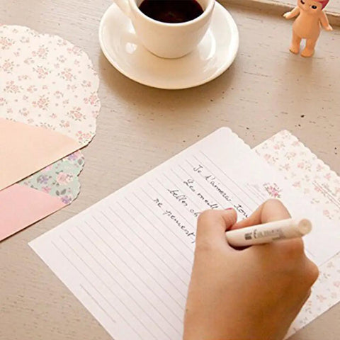 Person writing on stationery from Ultra Cute Kawaii Stationery Set With 32 Writing Papers And 16 Envelopes In Assorted Styles 7.1 By 5.2 Inch Letter Paper For Notes And Letters School Supplies Gift Ready.