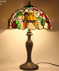 Tiffany Style Double Birds Stained Glass Table Lamp With 16 Inch Shade And 24 Inch Height, illuminated with warm glow.
