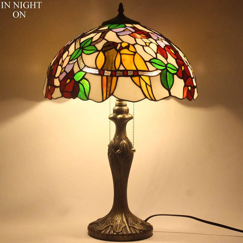 Tiffany Style Double Birds Stained Glass Table Lamp With 16 Inch Shade And 24 Inch Height, illuminated with warm glow.