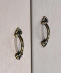 Vintage Bronze Mini Drawer Pulls Set Of 20, 1.85 Inch Antique Jewelry Box Handles on wooden cabinet doors.