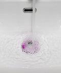 Water flowing into a sink with a Pink Silicone Bathtub Stopper With Chrome Plated Handle for effective drainage.