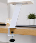 Height Adjustable Desk Leg For Desk Heightening And Organization attached to wooden desk, focus on clamp