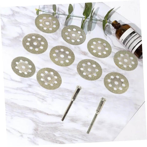 Ten Piece Diamond Cutting Discs Set For Rotary Tools Ultrafine Blades with discs and rods on marble surface