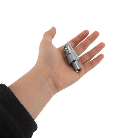 Hand holding Heavy Duty Brass Zerk Grease Coupler Adapter With Cross Fitting Nozzle Tip For Precision Hydraulic Lubrication Keeps Equipment Safe Using Standard Grease Gun Tools Easy Quick Connect Slick Design Makes Every Repair Job Way Faster Bad Ass Legit Gear.