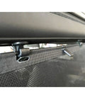 Close-up of Set Of Four Black Sliding Door Sun Shade Clip Hooks for Honda Odyssey 2005-2010 holding shade, showing rust-resistant construction.