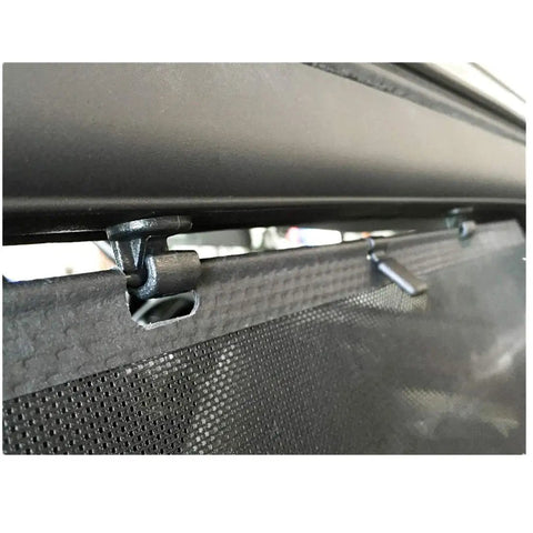 Close-up of Set Of Four Black Sliding Door Sun Shade Clip Hooks for Honda Odyssey 2005-2010 holding shade, showing rust-resistant construction.