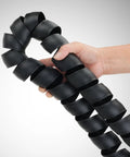 Hand holding Hydraulic Hose Protector Spiral Wrap, 2 Inch Outer Diameter, 10 Foot Length, Lightweight Protective Sleeve.