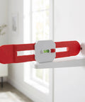 Retractable Spirit Level Tool for Air Conditioner Mounting Bracket with red arms and green bubble level on a wall.